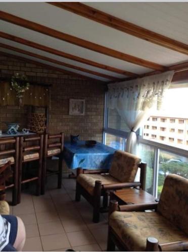 a living room with a blue table and chairs at Andante Villas in Kingsburgh