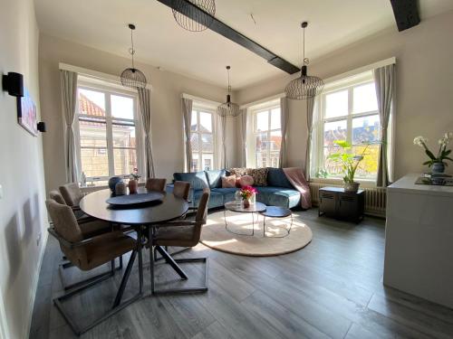 a living room with a table and a couch at Huize de Lekpoort - The City View - Historic Apartment in Vianen Center in Vianen