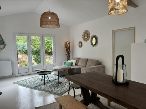 a living room with a couch and a table at La Playita - 4 chambres - Plage in Le Château-dʼOléron