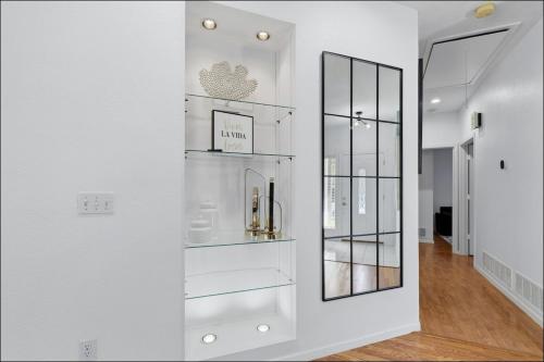 a white room with a shelf with a mirror at Homes in Prosper in Prosper