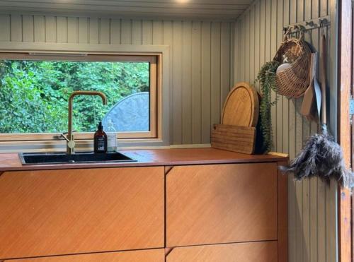 a kitchen with a sink and a window at Wonderful Family House At The West Coast in Løkken