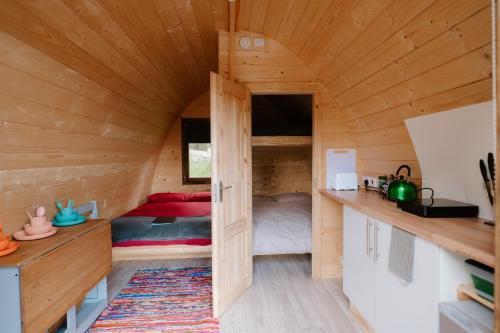 a room with a bed in a wooden cabin at Reservoir View Micro Cabin in Dol-y-gaer Station
