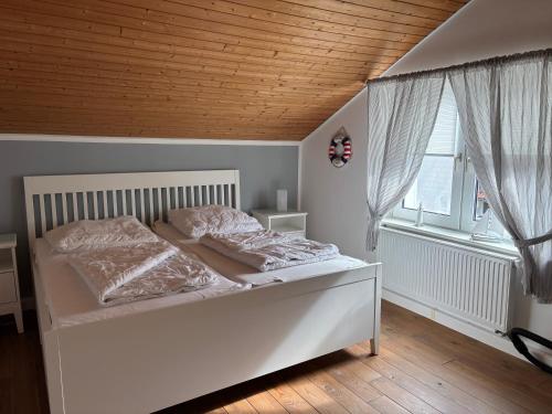 Ένα ή περισσότερα κρεβάτια σε δωμάτιο στο Frankenhof Zingst