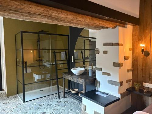 a bathroom with a sink and a glass shower at Le Gîte des Platanes in Spa