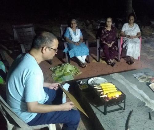 a group of people sitting around a table at Mystique Copper Smart Villa in Sadāshivgarh