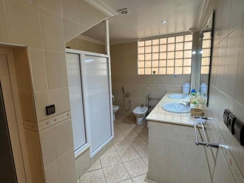 a bathroom with a sink and a toilet at Luxury apartment with garden view in Agadir