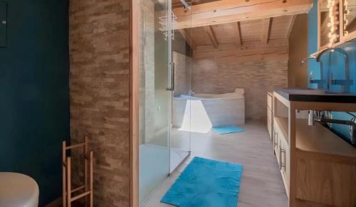 a bathroom with a shower with a glass door at Chalet d'Aussois Lerovi in Aussois