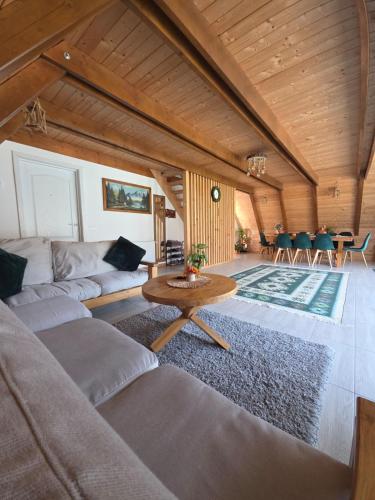 a living room with a couch and a table at Casuta Armonia in Moisei