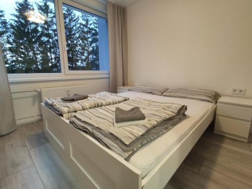 a white bed in a room with a window at Rasa in Marijampolė