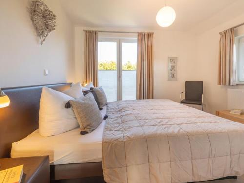 a bedroom with a large bed and a window at Sagard - Ferienhaus Rubin in Sagard