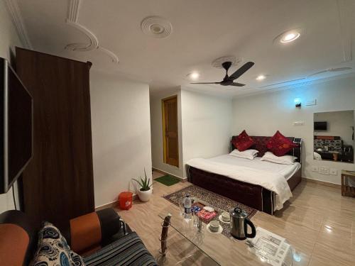 a bedroom with a bed and a living room at Hotel Crescent in Srinagar