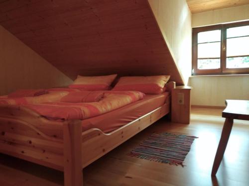 a bedroom with a bed in a attic at Gläserberg in Langenbach
