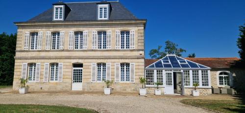 a large building with a lot of windows at Suite Majorelle du Château in Gaillan-en-Médoc