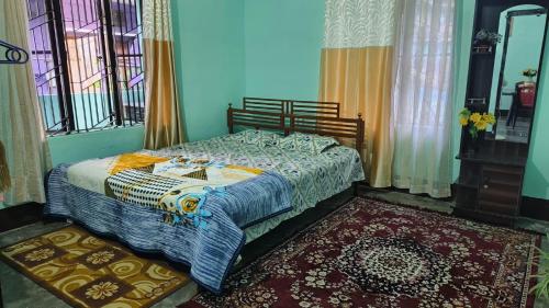 a bedroom with a bed in a room with windows at Mitali Homestay in Dibrugarh