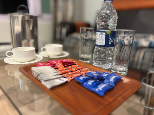 a wooden tray with a bottle of water and napkins at Hotel Crescent in Srinagar