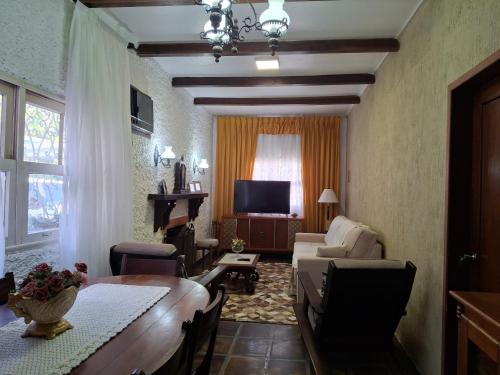 a living room with a couch and a table at Pousada casa dos sonhos in São Gabriel
