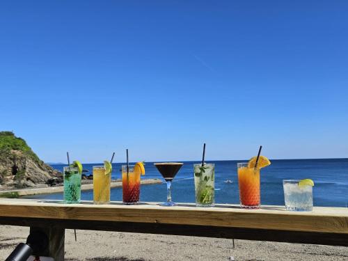 a group of drinks on a table at the beach at Millendreath Oean View Villa in Saint Martin