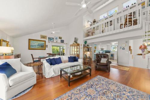 a living room with a white couch and a table at The Turtle Nest in Sanibel