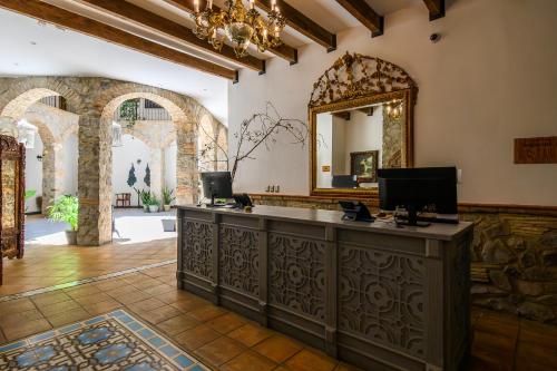 a salon with a large mirror and a counter at Villa Toscana ValQuirico Lofts & Suites Hotel Boutique in Santeagueda