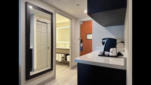 a room with a bathroom with a sink and a mirror at Holiday Inn Express Brampton by IHG in Brampton