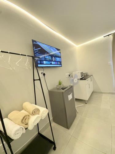 a hospital room with a tv and towels at Ocean Whisper Room 6 minutes away from the beach in Cape Town