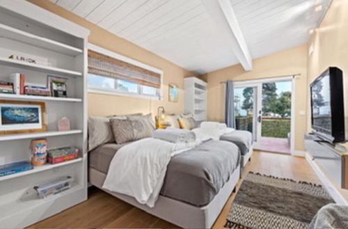 a bedroom with a large bed and a couch at Pleasure Point Surf Retreat in Santa Cruz