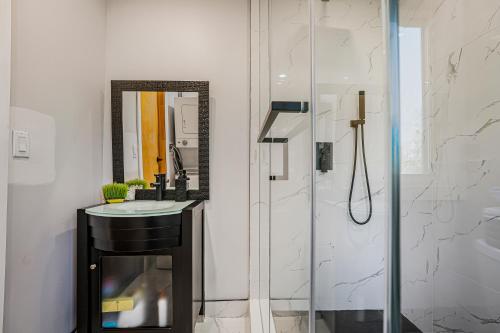 a bathroom with a shower and a sink and a mirror at Rustic Lakefront Cottage with Fire Pit & Scenic Views in Brechin
