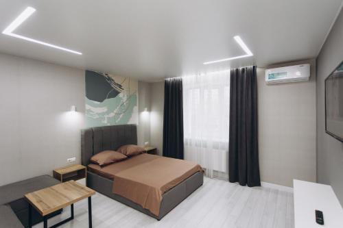 a small bedroom with a bed and a window at Luxury Apartment Lushpy Avenue - Hotel Standard in Dobrovelychkivka