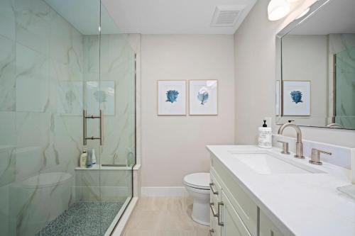 a bathroom with a shower and a sink and a toilet at Surfside 12 A4 in Sanibel