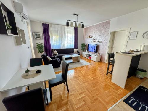 a living room with a couch and a table at Apartman EMA in Požarevac