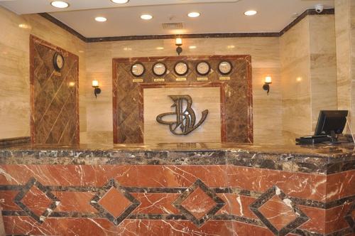 a lobby with a bar with clocks on the wall at Best View Pyramids Hotel in Cairo