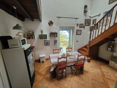 a kitchen and dining room with a table and a refrigerator at Gurbialde Etxea in Mutriku