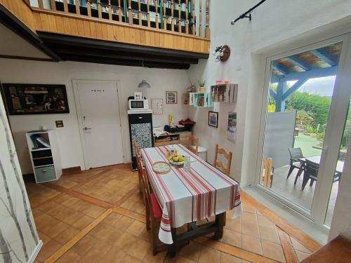 a kitchen with a table with a red and white table cloth at Gurbialde Etxea in Mutriku