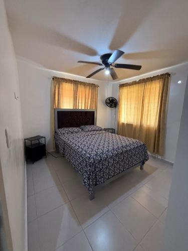 a bedroom with a bed and a ceiling fan at Comfort and tranquility in one place in La Estrella