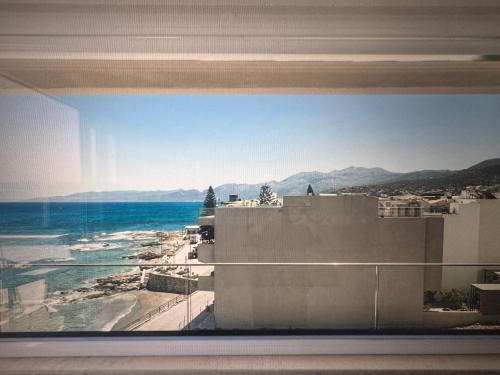 a view of the ocean from a building at Sea waves suite in Hersonissos
