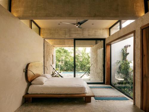 a bedroom with a bed and a large window at Casa M in Macario Gomez