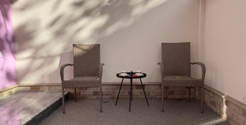 twee stoelen en een tafel in een kamer bij MK Luxury Serviced Apartment # 2 in Chişinău