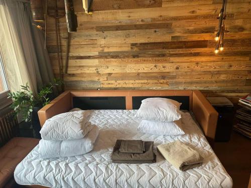 a bed in a room with a wooden wall at Zermatt Apartment in Zermatt