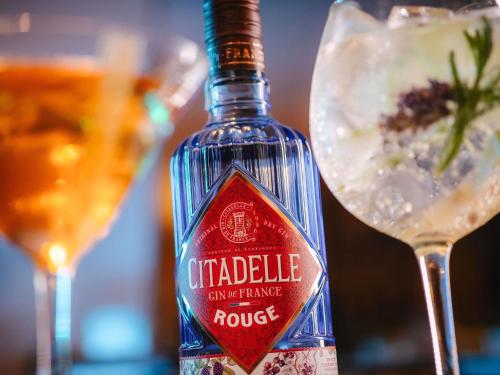 a bottle ofokeduliculiculicrisis sitting next to a wine glass at Maison Sofia - MGallery in Sofia