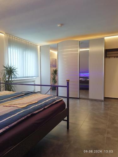 a bedroom with a bed and a room with a view at Ferienwohnung Jessica in Mastershausen