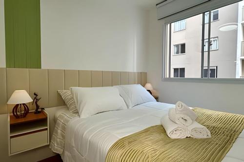 um quarto com uma cama grande com toalhas em O mais completo Studio com sacada prox Tokio Marine Hall em São Paulo