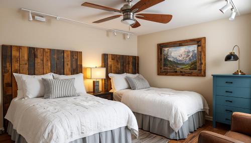 a bedroom with two beds and a ceiling fan at Aspen Chic in Aspen