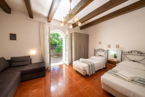 a living room with two beds and a couch at Appartamenti Ischia la Sentinella in Ischia