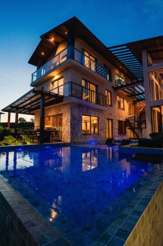 a large house with a swimming pool in front of it at Casa Oceano-Praia do Forte, Cond com Acesso à Praia, Piscina Aquecida in Praia do Forte