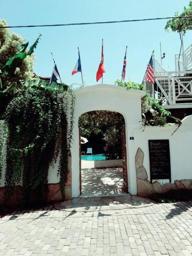 an entrance to a building with flags on it at Central Park Otel - Adult Only in Dalyan