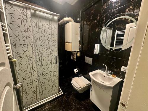 a small bathroom with a toilet and a sink at Golden Kent APART&SUİTES in Istanbul