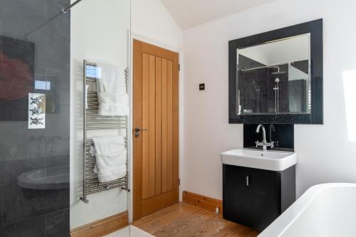 ein Badezimmer mit Waschbecken und Spiegel in der Unterkunft Lovely Double Room for One Person in Bexley