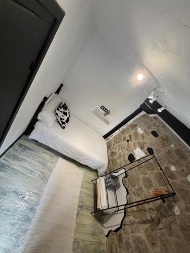 a bedroom with a bed and a table in it at La Casuca ONE De Lebeña in Lebena