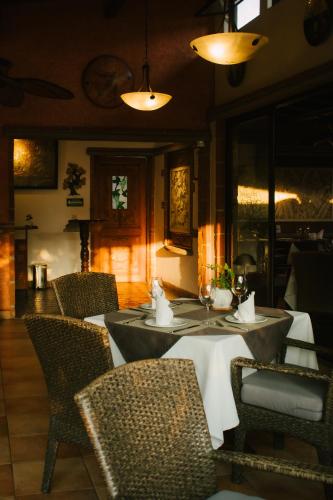a dining room with tables and chairs and lights at La Buena Vibra Wellness Resort & Spa in Tepoztlán