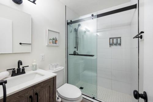 a bathroom with a shower and a toilet and a sink at Whispering Pines: Foosball Grill More in Mountainaire